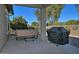 Relaxing backyard patio featuring a hot tub and grill at 7132 W Trenton Way, Florence, AZ 85132