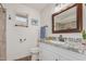 Updated bathroom with granite countertop and walk-in shower at 8039 E Madero Ave, Mesa, AZ 85209