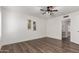 Well-lit bedroom with hardwood floors and ceiling fan at 8039 E Madero Ave, Mesa, AZ 85209