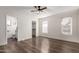 Spacious bedroom with wood floors, ceiling fan, and ensuite bathroom at 8039 E Madero Ave, Mesa, AZ 85209