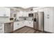Modern kitchen with white cabinets, granite countertops, and stainless steel appliances at 8039 E Madero Ave, Mesa, AZ 85209