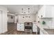 Updated kitchen featuring white cabinets and granite countertops at 8039 E Madero Ave, Mesa, AZ 85209