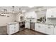 Modern kitchen with white cabinets, granite counters, and stainless steel appliances at 8039 E Madero Ave, Mesa, AZ 85209