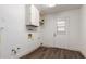 Bright laundry room with built-in cabinets and vinyl flooring at 8039 E Madero Ave, Mesa, AZ 85209