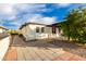 Side yard with brick pathway, leading to a detached structure and patio at 8039 E Madero Ave, Mesa, AZ 85209