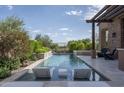 Luxury backyard pool with spacious patio and seating at 3089 S Prospector Cir, Gold Canyon, AZ 85118