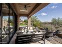 Relaxing covered patio with seating area, fire pit, and views of the surrounding landscape at 3149 S Prospector Cir, Gold Canyon, AZ 85118