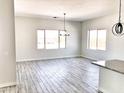 Bright dining room with wood-look floors and large windows at 2667 S Tristan Trl, Gold Canyon, AZ 85118
