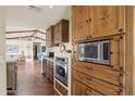 Spacious kitchen with island, stainless steel appliances, and custom wood cabinets at 51008 W Pete Rd, Aguila, AZ 85320