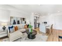 Open-concept living room, kitchen, and island with seating at 3131 N Central Ave # 3019, Phoenix, AZ 85012