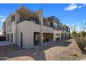 Modern luxury home with stone accents and large windows at 37200 N Cave Creek Rd # 1111, Scottsdale, AZ 85262