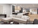 Open concept living space with modern sectional sofa and kitchen views at 6932 E 1St St, Scottsdale, AZ 85251
