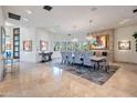 Elegant dining room with stone fireplace and seating for eight at 10040 E Happy Valley Rd # 1, Scottsdale, AZ 85255