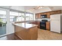 Eat-in kitchen with wood cabinets and black appliances at 8312 E Orange Blossom Ln, Scottsdale, AZ 85250