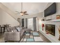 Living room with fireplace, sectional sofa, and adjacent dining area at 3017 W Sahuaro Dr, Phoenix, AZ 85029