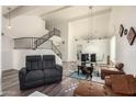 Open living area with high ceilings and a curved staircase at 7233 W Corrine Dr, Peoria, AZ 85381