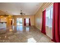 Bright and spacious living room with tile flooring and red curtains at 21521 S 215Th Pl, Queen Creek, AZ 85142