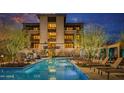 Luxury condo community with a resort-style pool and comfortable seating at 18720 N 101St St # 3013, Scottsdale, AZ 85255