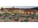 Beautiful home exterior with a three car garage and desert landscaping at 8510 E Tecolote Cir, Scottsdale, AZ 85266