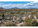 Aerial view of a desert lot with cacti and mountain views at 8614 E Artisan Pass Pass # 125, Scottsdale, AZ 85266