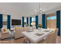 Open concept dining area with marble table and modern chandelier at 701 S Del Rancho --, Mesa, AZ 85208