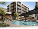 Community pool with surrounding lounge and dining areas at 19355 N 73Rd Way # 2020, Scottsdale, AZ 85255