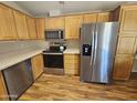 Kitchen with stainless steel appliances and wood cabinets at 650 N Hawes Rd # 4829, Mesa, AZ 85207