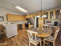 Eat-in kitchen with wood cabinets and stainless steel appliances at 650 N Hawes Rd # 4829, Mesa, AZ 85207