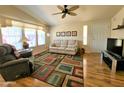 Living room with light colored sofa and wood flooring at 650 N Hawes Rd # 4829, Mesa, AZ 85207