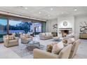 Large living room with fireplace and access to backyard at 6940 E Indian Bend Rd, Paradise Valley, AZ 85253