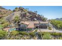 Stunning aerial view of home nestled into mountainside at 5339 E Desert Vista Rd, Paradise Valley, AZ 85253