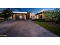 Modern home exterior with a two-car garage and landscaping at 10535 E Paradise Dr, Scottsdale, AZ 85259