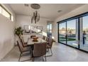 Modern dining room with a large table and sliding glass doors at 10535 E Paradise Dr, Scottsdale, AZ 85259