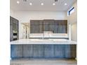 Modern kitchen with large island and marble countertop at 12140 N 106Th St, Scottsdale, AZ 85259