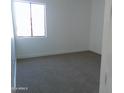 Spacious bedroom with neutral carpeting and large window for natural light at 846 N Pueblo Dr # 134, Casa Grande, AZ 85122