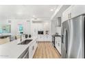 Modern kitchen with white shaker cabinets, stainless steel appliances, and an island at 3131 N Central Ave # 4012, Phoenix, AZ 85012