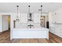 Modern kitchen with white cabinets and island at 7583 W Gelding Dr, Peoria, AZ 85381