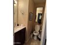 Small bathroom with toilet, sink, and vanity at 3840 N 43 Ave # 50, Phoenix, AZ 85031