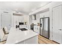 White kitchen with stainless steel appliances and island at 3131 N Central Ave # 6012, Phoenix, AZ 85012