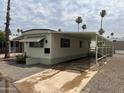 Mobile home with carport and palm trees at 7300 N 51St Ave # 208, Glendale, AZ 85301