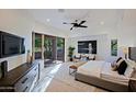 Spacious bedroom with large windows, a king-size bed, and access to a private patio at 41327 N 106Th St, Scottsdale, AZ 85262