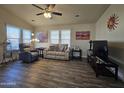 Living room with wood-look floors and comfy seating at 650 N Hawes Rd # 3423, Mesa, AZ 85207
