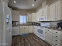 Well-equipped kitchen with white cabinets and granite counters at 650 N Hawes Rd # 3423, Mesa, AZ 85207