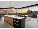 Modern kitchen with island and high-end appliances, offering sunset views at 4796 E Charles Dr, Paradise Valley, AZ 85253
