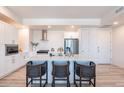 Modern kitchen with white cabinets, stainless steel appliances, and a large island with seating at 3131 N Central Ave # 3013, Phoenix, AZ 85012
