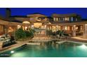 Expansive backyard oasis with a sparkling pool and shade structure at 15 Biltmore Estates Dr, Phoenix, AZ 85016
