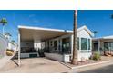 Mobile home exterior with covered patio and landscaping at 623 Hawks Eye Dr # 623, Apache Junction, AZ 85119