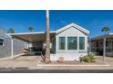 Mobile home exterior with covered patio and landscaping at 623 Hawks Eye Dr # 623, Apache Junction, AZ 85119