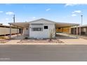 Mobile home with covered carport and small front yard at 3330 E Main St # 9, Mesa, AZ 85213