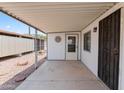 Covered patio with access to the front door and adjacent to a gravel area at 3330 E Main St # 9, Mesa, AZ 85213